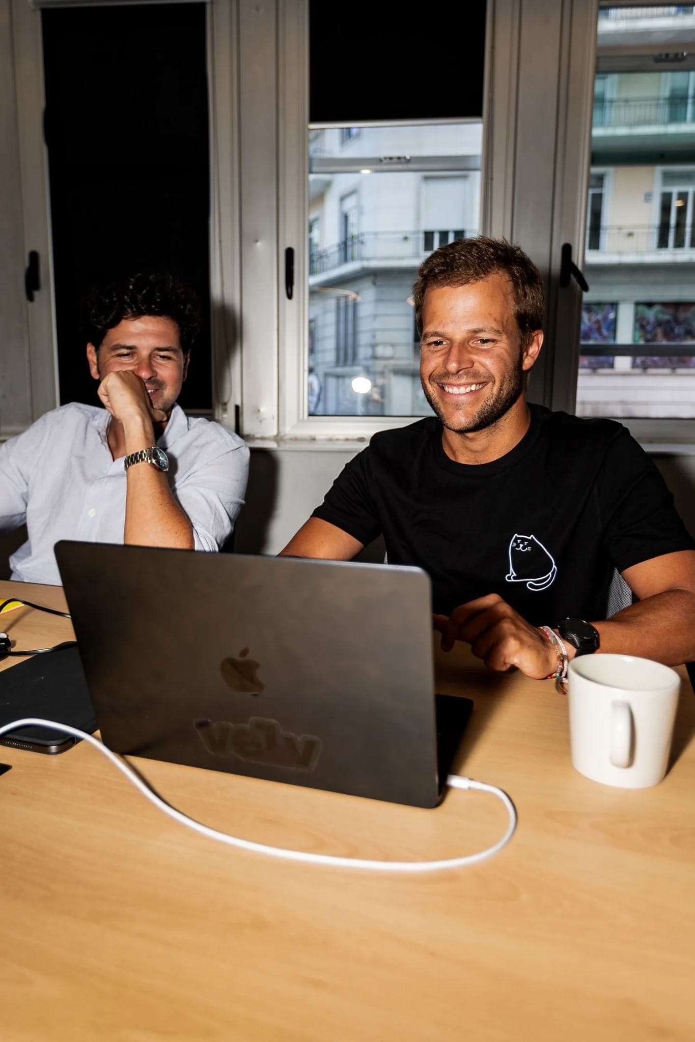 Two Velv engineers collaborating at a laptop