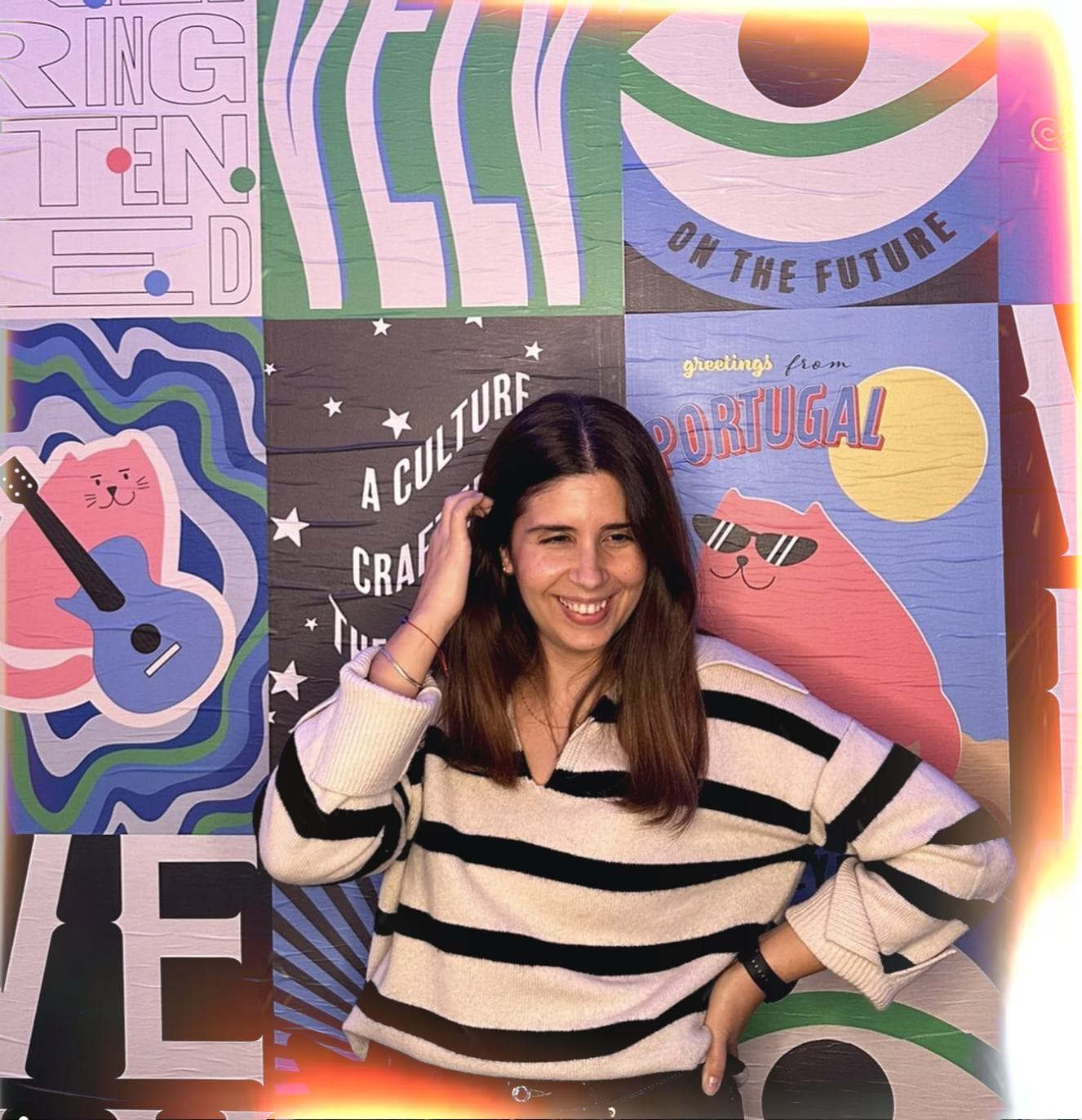 Velv team member smiling in front of a colorful mural